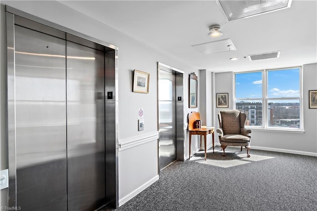 living area with baseboards, carpet, visible vents, and elevator