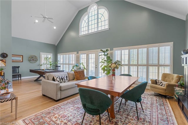 living room with a towering ceiling, light hardwood / wood-style flooring, ceiling fan, and billiards