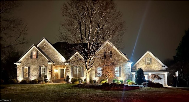 front facade with a garage and a lawn