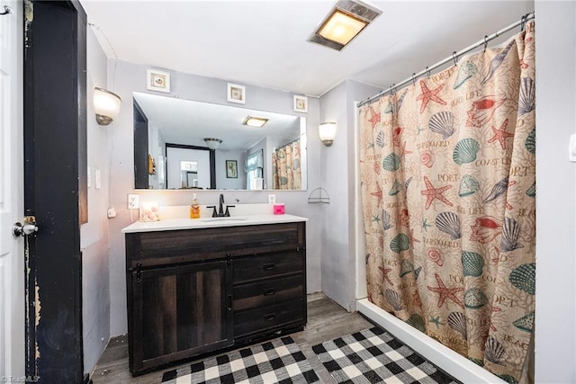 7387 NC Highway 62, Trinity, NC 27370 - full bathroom with vanity, a shower with curtain, and wood finished floors