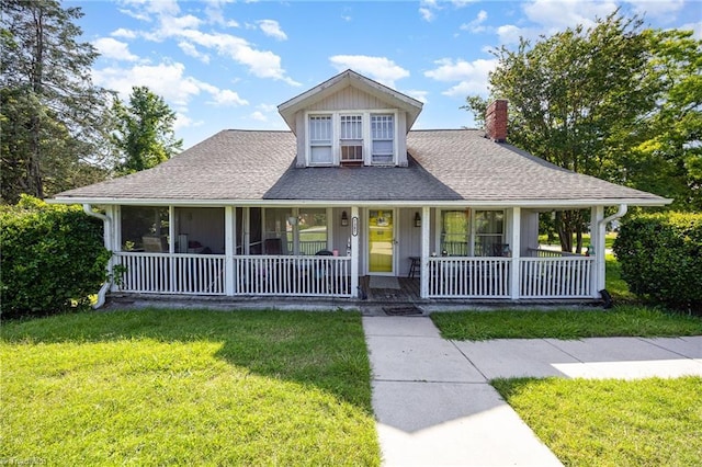 7387 NC Highway 62, Trinity, NC 27370 - country-style home featuring a chimney, a front yard, a porch, and roof with shingles