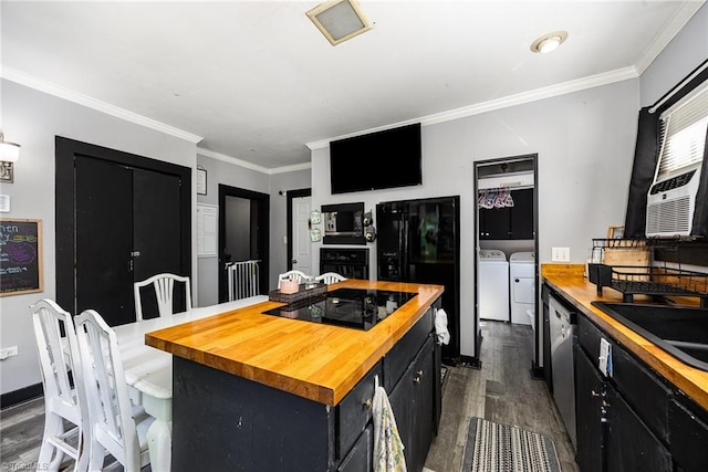 7387 NC Highway 62, Trinity, NC 27370 - kitchen featuring butcher block counters, independent washer and dryer, black appliances, dark cabinets, and dark wood finished floors