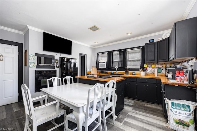 7387 NC Highway 62, Trinity, NC 27370 - kitchen featuring black appliances, wood counters, light wood-style floors, crown molding, and dark cabinetry