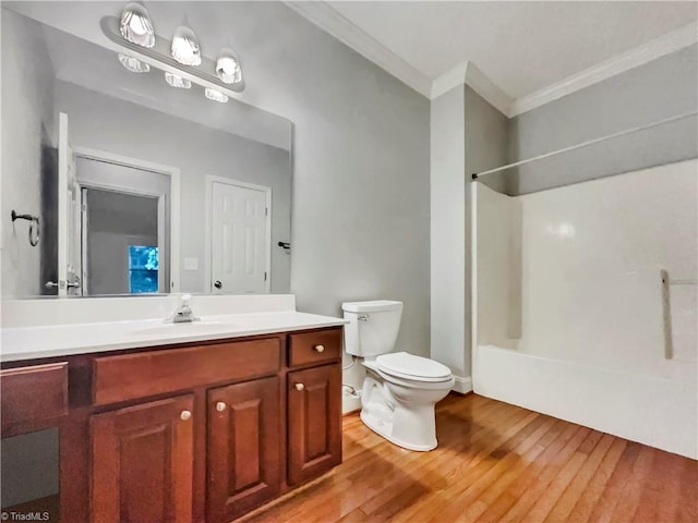 full bath with toilet, vanity, crown molding, and wood finished floors