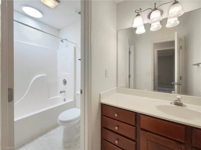 bathroom featuring marble finish floor, tub / shower combination, vanity, and toilet