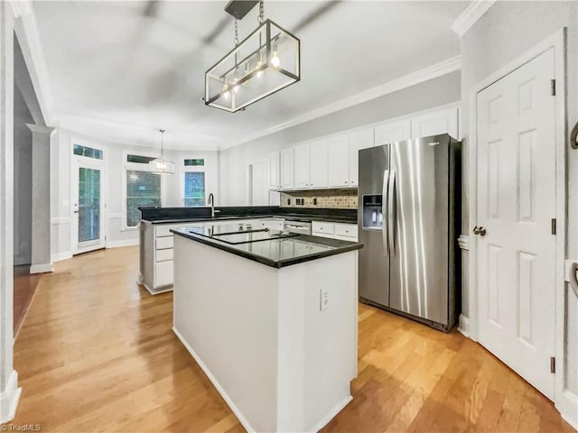 kitchen with a peninsula, white cabinetry, stainless steel fridge with ice dispenser, light wood finished floors, and dark countertops