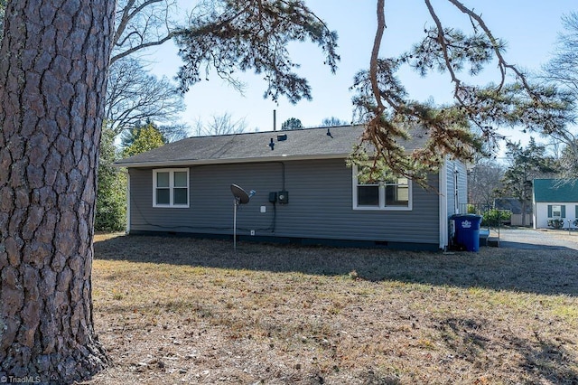 rear view of property with a lawn