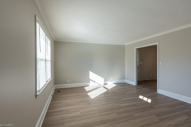 spare room featuring crown molding and hardwood / wood-style flooring