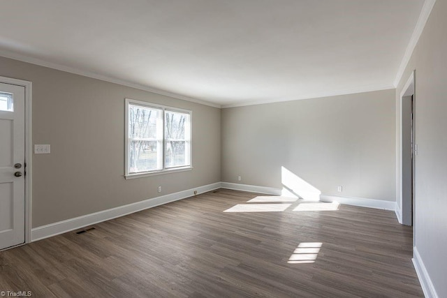 entrance foyer with dark wood-type flooring and crown molding