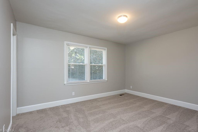 empty room featuring light carpet