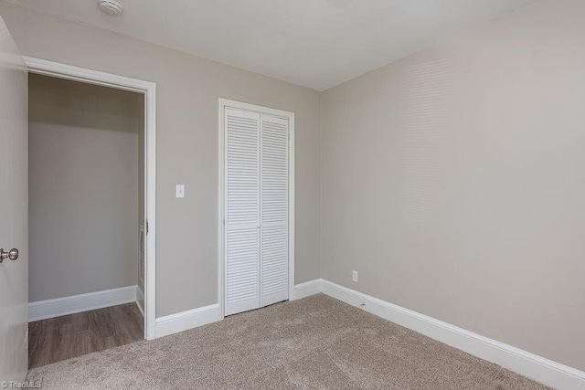 unfurnished bedroom featuring a closet and carpet flooring