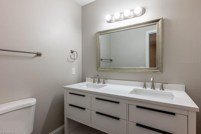 bathroom featuring vanity and toilet