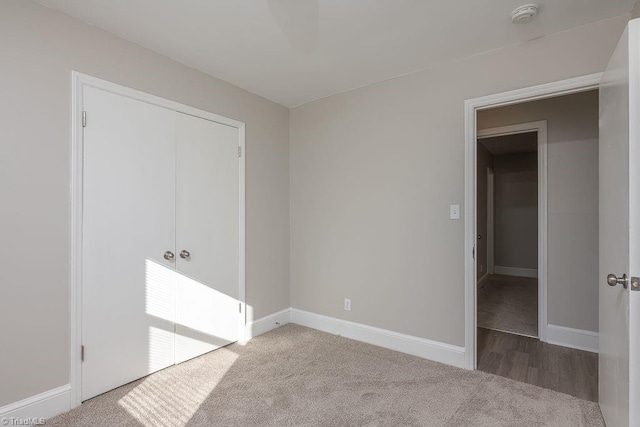 unfurnished bedroom with carpet flooring and a closet