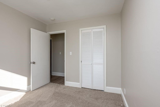 unfurnished bedroom with carpet and a closet