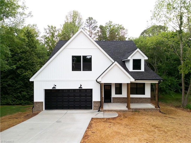 400 Cotswold Ln, King, NC 27021 - modern inspired farmhouse featuring brick siding, covered porch, a garage, concrete driveway, and roof with shingles