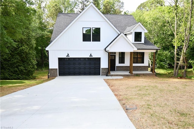 400 Cotswold Ln, King, NC 27021 - modern inspired farmhouse with covered porch, roof with shingles, concrete driveway, an attached garage, and a front lawn