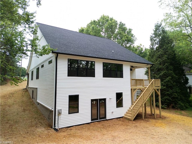 rear view of house with stairs, a shingled roof, and a wooden deck