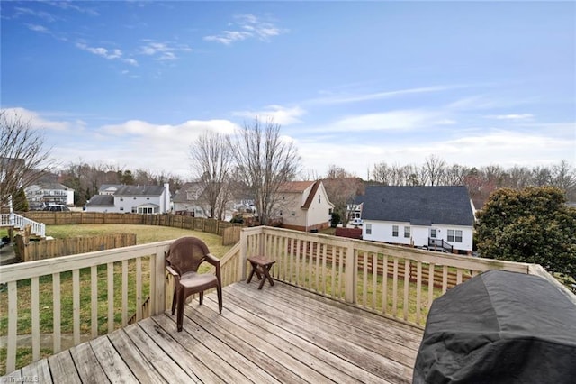 deck featuring a residential view, a lawn, and fence