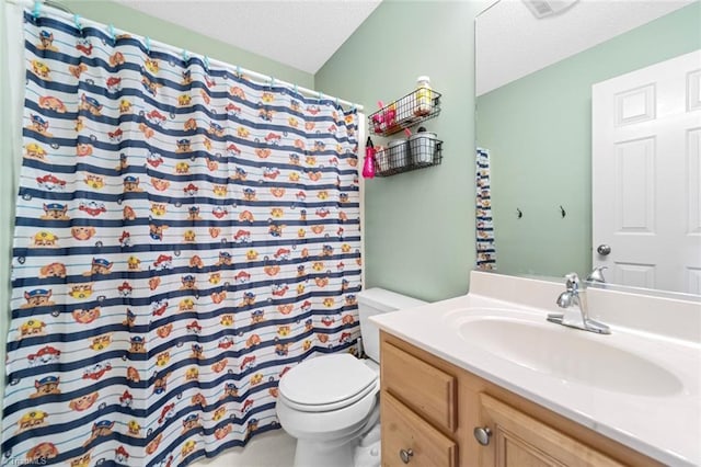 bathroom with a textured ceiling, a shower with shower curtain, vanity, and toilet