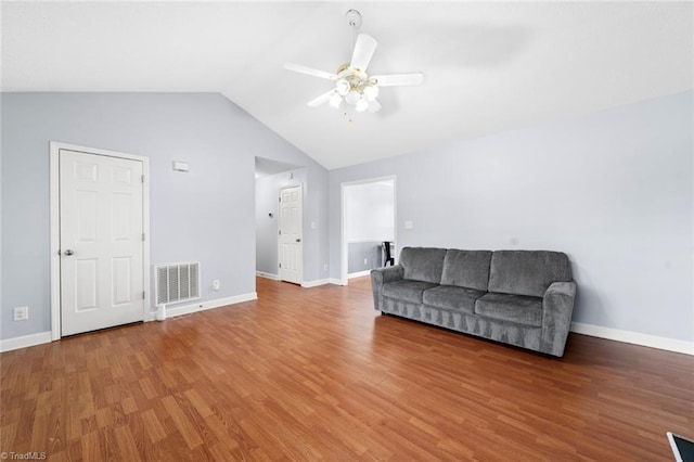 living area featuring baseboards, visible vents, a ceiling fan, wood finished floors, and vaulted ceiling