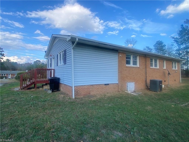 view of side of home featuring a yard and cooling unit