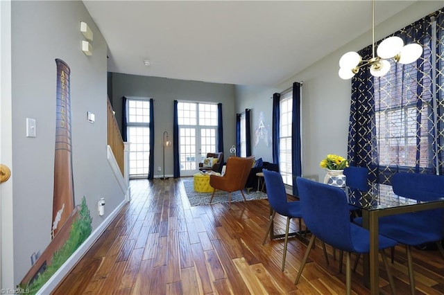 dining area with a chandelier and wood-type flooring