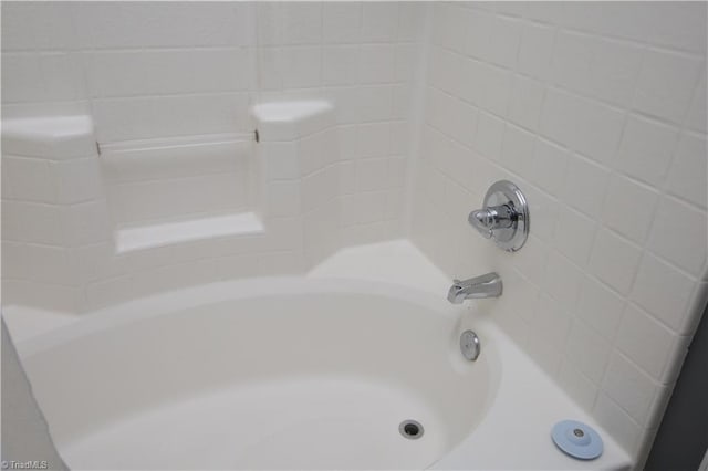 room details featuring washtub / shower combination