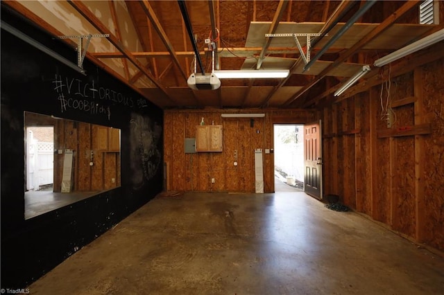 garage with electric panel and a garage door opener