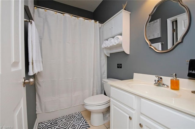 bathroom featuring tile patterned floors, vanity, curtained shower, and toilet