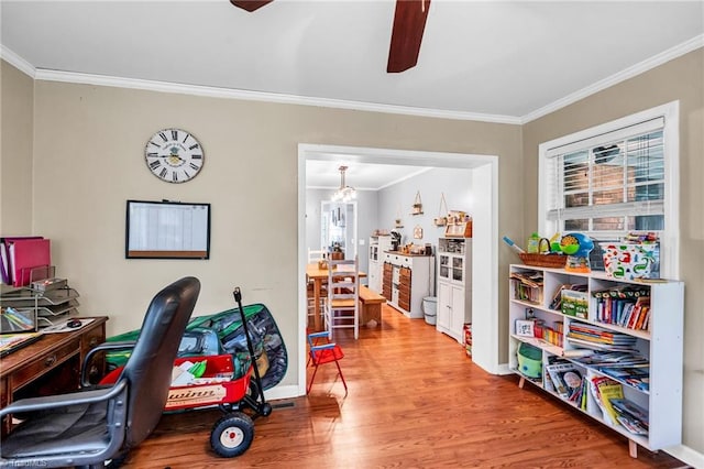 home office with ceiling fan with notable chandelier, ornamental molding, and wood-type flooring