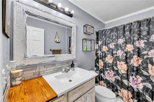 bathroom featuring crown molding, backsplash, vanity, and toilet