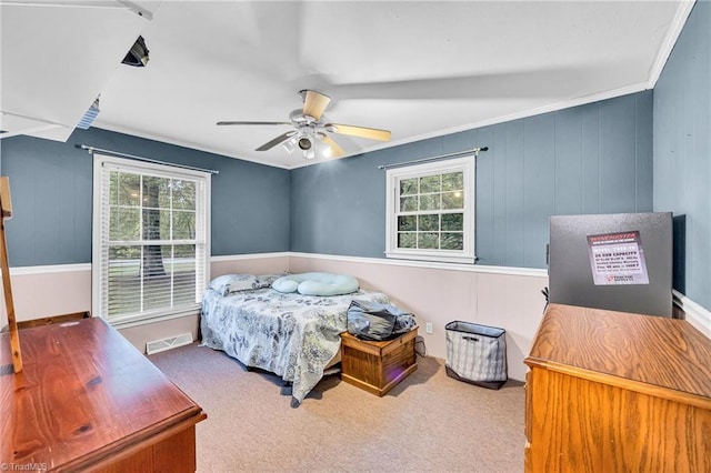 bedroom featuring carpet flooring, multiple windows, ceiling fan, and crown molding