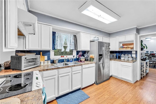 kitchen featuring sink, white cabinets, light hardwood / wood-style flooring, appliances with stainless steel finishes, and crown molding