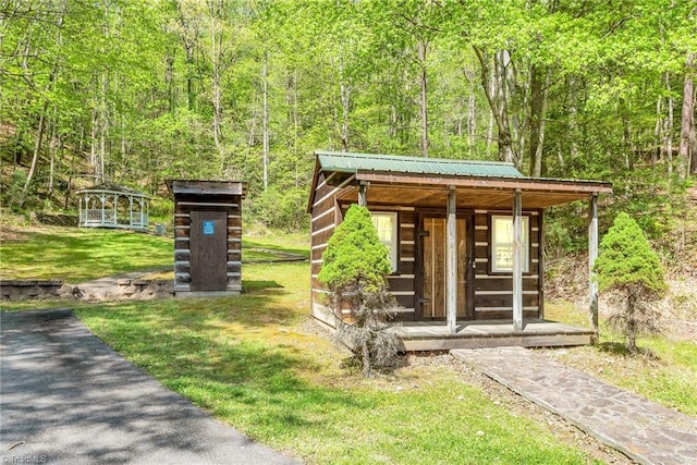 exterior space with a gazebo and a lawn