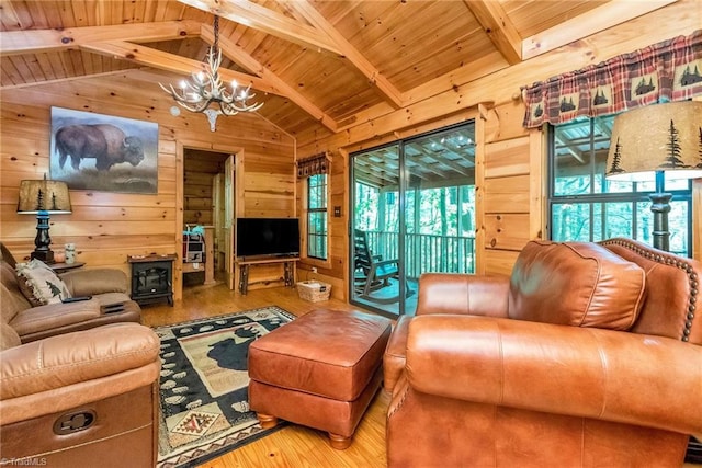 living room featuring wooden walls, wood-type flooring, and plenty of natural light