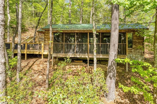 view of outbuilding featuring a sunroom