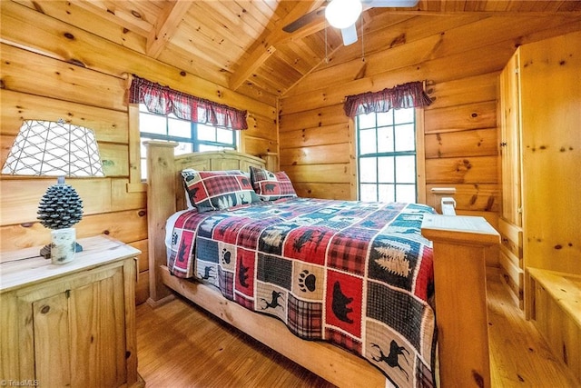 bedroom with wood-type flooring, vaulted ceiling with beams, wooden ceiling, and wood walls