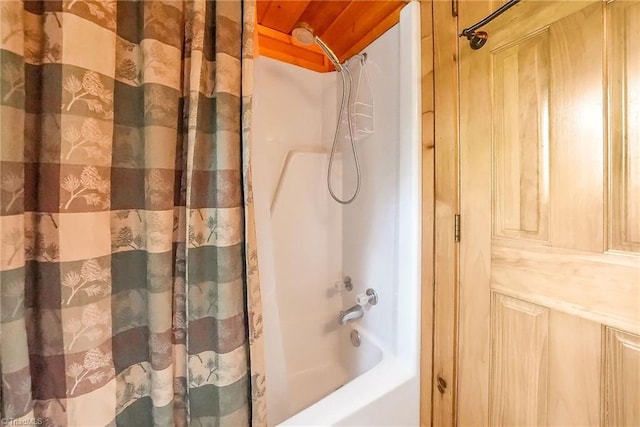 bathroom with shower / bath combo with shower curtain