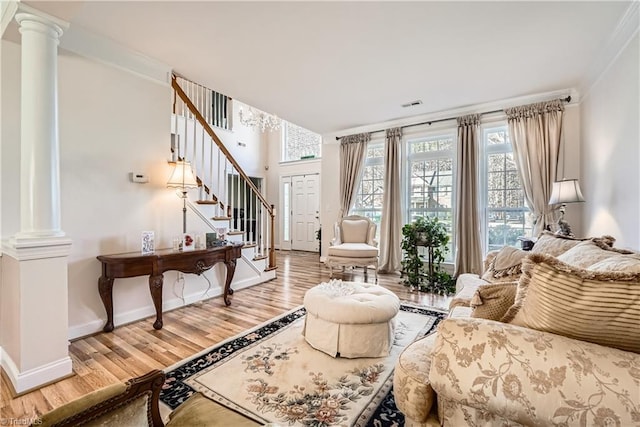 sitting room with ornate columns, crown molding, and hardwood / wood-style flooring