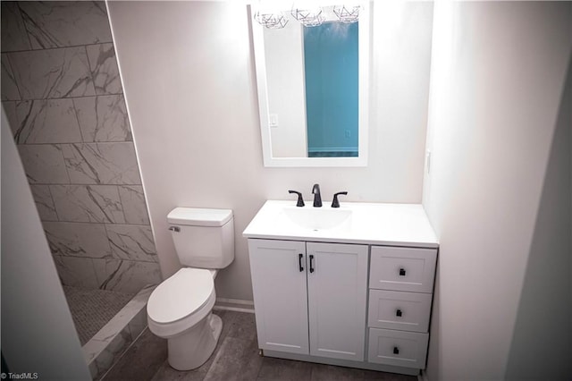 full bathroom with a stall shower, vanity, and toilet