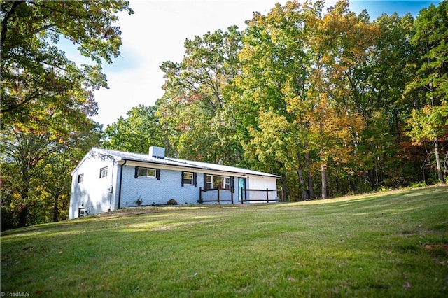 view of front of property with a front yard and brick siding