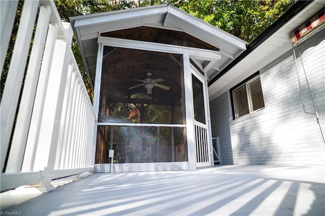 exterior space featuring brick siding and a ceiling fan