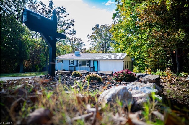 single story home featuring metal roof