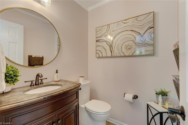 bathroom featuring toilet, crown molding, and vanity