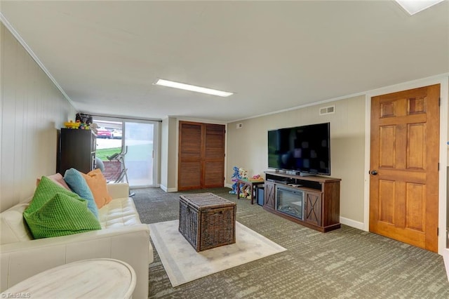 living room featuring carpet floors, baseboards, and ornamental molding