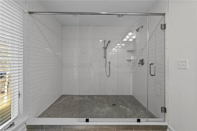 bathroom with a shower with door