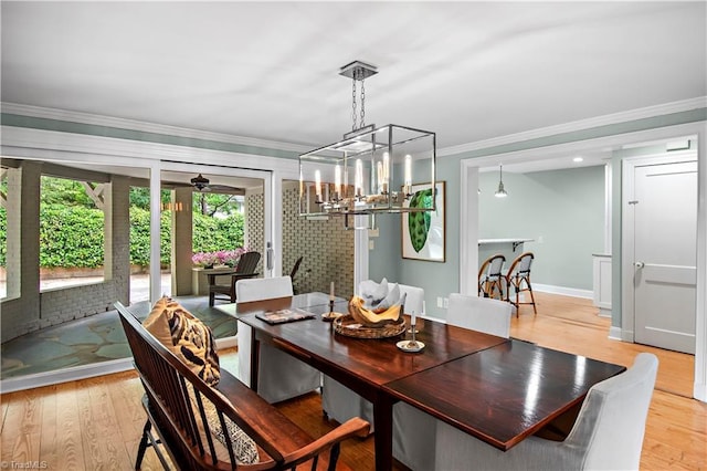 968 Avon Rd, Winston-Salem, NC 27104 - dining area featuring crown molding, a chandelier, light wood-style floors, and baseboards