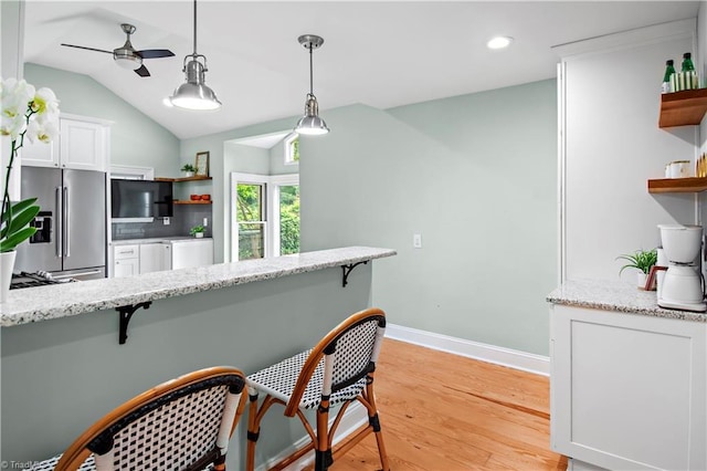 968 Avon Rd, Winston-Salem, NC 27104 - kitchen with open shelves, high quality fridge, a breakfast bar, ceiling fan, and white cabinetry