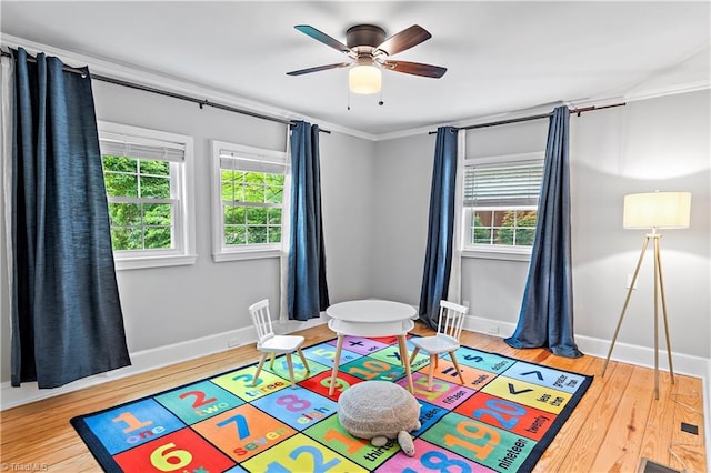 968 Avon Rd, Winston-Salem, NC 27104 - game room with baseboards, wood finished floors, ceiling fan, and crown molding