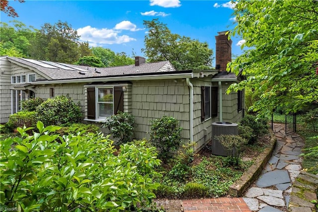 968 Avon Rd, Winston-Salem, NC 27104 - view of side of property with a chimney, central air condition unit, and a shingled roof